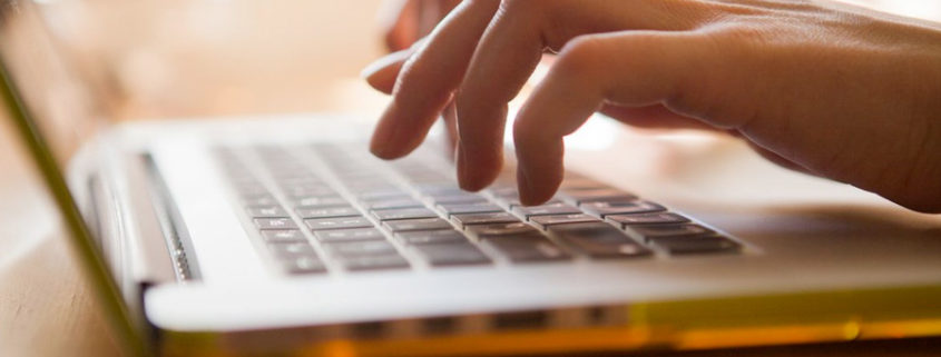 Writing Book on Laptop